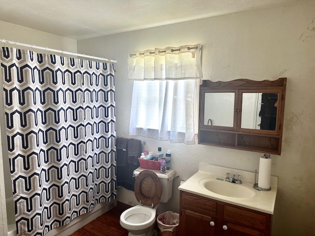 4350 Dallas Ave, Beaumont, TX 77703 - bathroom featuring vanity, a textured wall, and wood finished floors