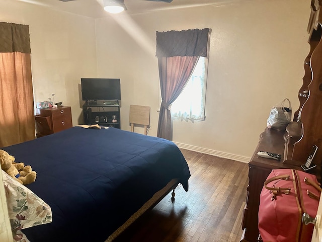 bedroom featuring ceiling fan and dark hardwood / wood-style floors