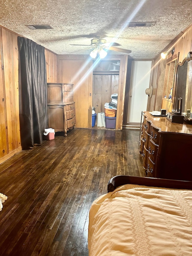 4350 Dallas Ave, Beaumont, TX 77703 - bedroom featuring hardwood / wood-style floors, wood walls, and a textured ceiling