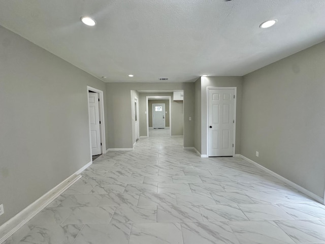 empty room featuring a textured ceiling