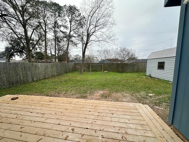 wooden deck featuring a lawn