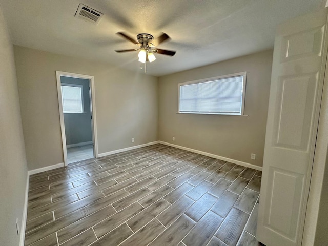 unfurnished room featuring ceiling fan and a healthy amount of sunlight