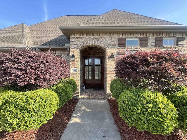 156 Remington Cir, Lumberton, TX 77657 - entrance to property featuring roof with shingles, brick siding, and french doors
