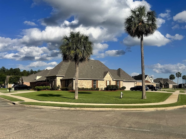156 Remington Cir, Lumberton, TX 77657 - view of front of house featuring an attached garage, stone siding, a front lawn, and concrete driveway