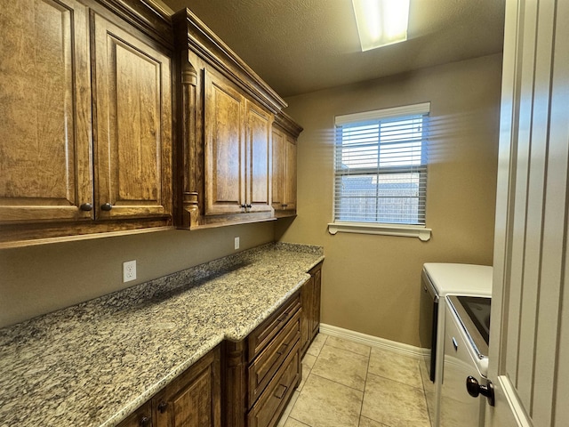 156 Remington Cir, Lumberton, TX 77657 - laundry room with washer and dryer, baseboards, cabinet space, and light tile patterned flooring