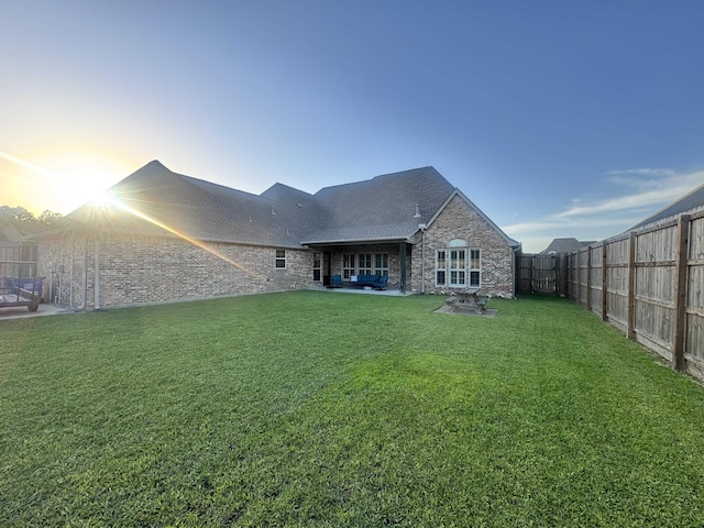 156 Remington Cir, Lumberton, TX 77657 - back of property featuring a patio area, brick siding, a shingled roof, and stone siding