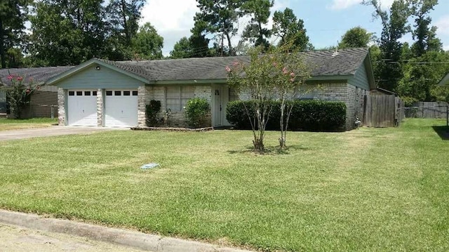 ranch-style home featuring a front yard and a garage