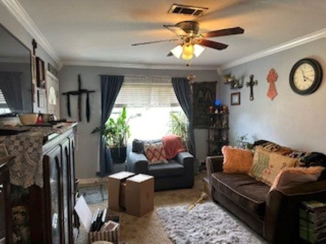 living room featuring a barn door, ceiling fan, and ornamental molding