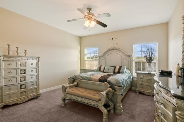 bedroom featuring multiple windows, dark carpet, and ceiling fan