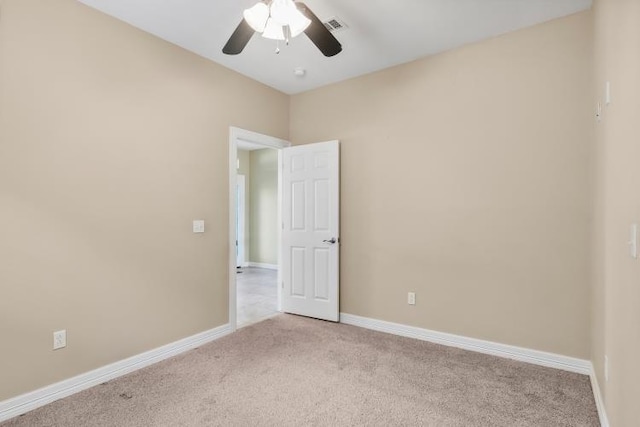 unfurnished room with light colored carpet and ceiling fan