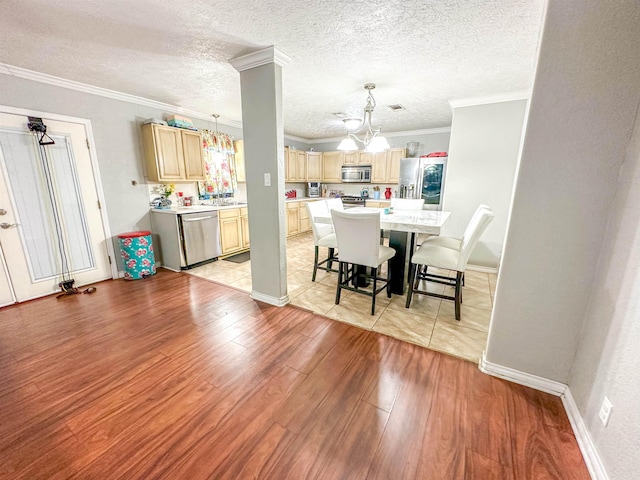 671 Birchwood Dr, Port Neches, TX 77651 - dining space with a chandelier, light wood-style flooring, ornamental molding, a textured ceiling, and baseboards
