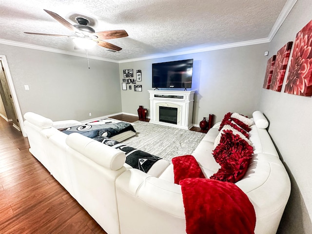 671 Birchwood Dr, Port Neches, TX 77651 - living area with wood finished floors, ceiling fan, a textured ceiling, ornamental molding, and a glass covered fireplace
