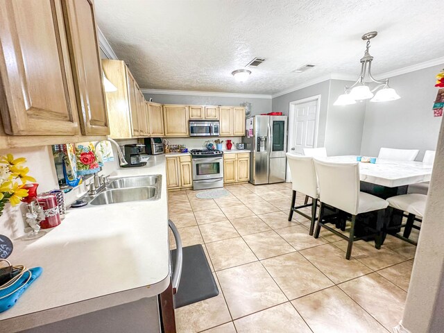 671 Birchwood Dr, Port Neches, TX 77651 - kitchen featuring stainless steel appliances, ornamental molding, light countertops, light tile patterned floors, and a sink