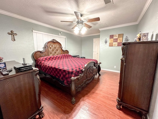 671 Birchwood Dr, Port Neches, TX 77651 - bedroom featuring wood finished floors, a textured ceiling, ornamental molding, a ceiling fan, and baseboards