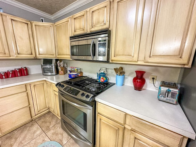 671 Birchwood Dr, Port Neches, TX 77651 - kitchen featuring stainless steel appliances, light countertops, light brown cabinets, ornamental molding, and light tile patterned flooring