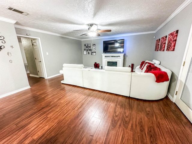 671 Birchwood Dr, Port Neches, TX 77651 - living room featuring wood finished floors, a fireplace, ceiling fan, a textured ceiling, and crown molding