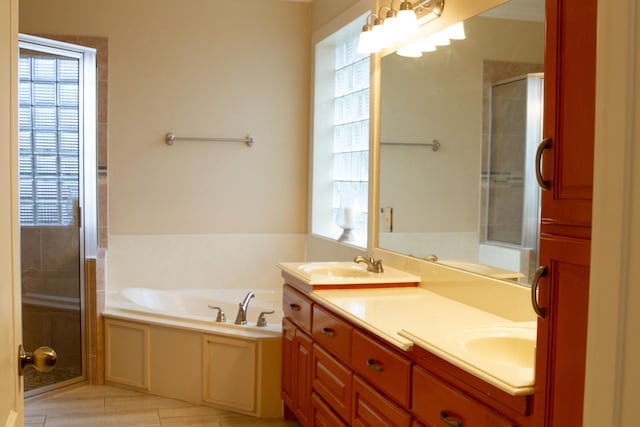 bathroom featuring vanity, tile patterned flooring, plenty of natural light, and plus walk in shower