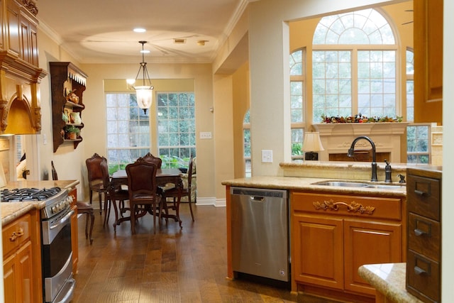 kitchen with pendant lighting, appliances with stainless steel finishes, dark wood-type flooring, sink, and crown molding