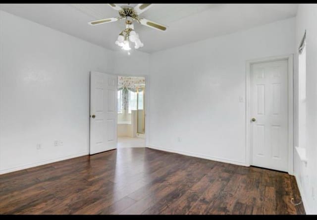 unfurnished room with ceiling fan, baseboards, and dark wood-style flooring