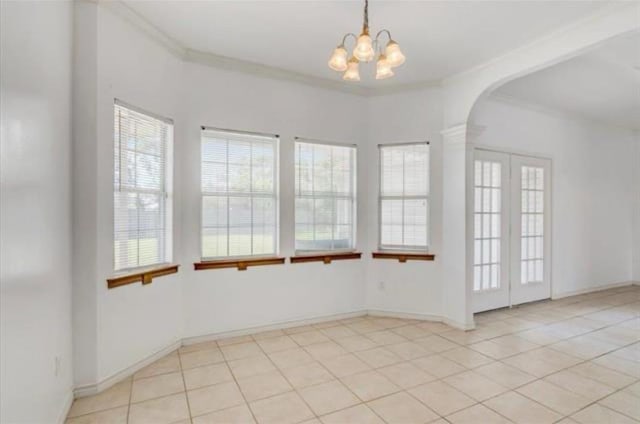 unfurnished room featuring light tile patterned floors, crown molding, and an inviting chandelier