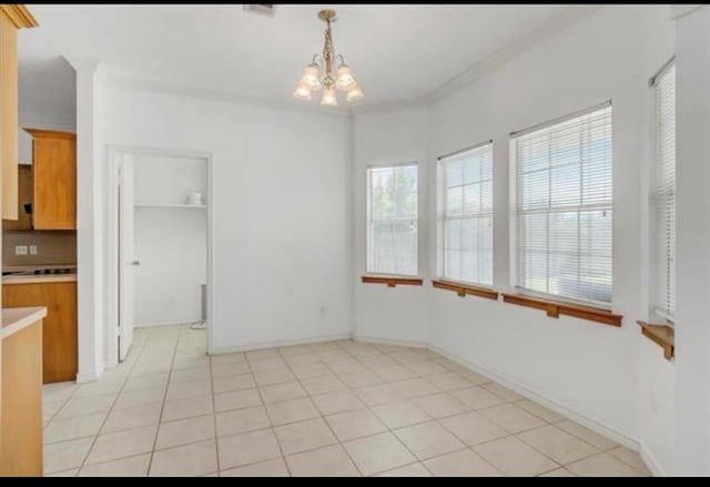 unfurnished dining area with light tile patterned floors, baseboards, and a chandelier