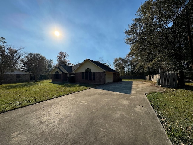 ranch-style home with a front lawn and a garage