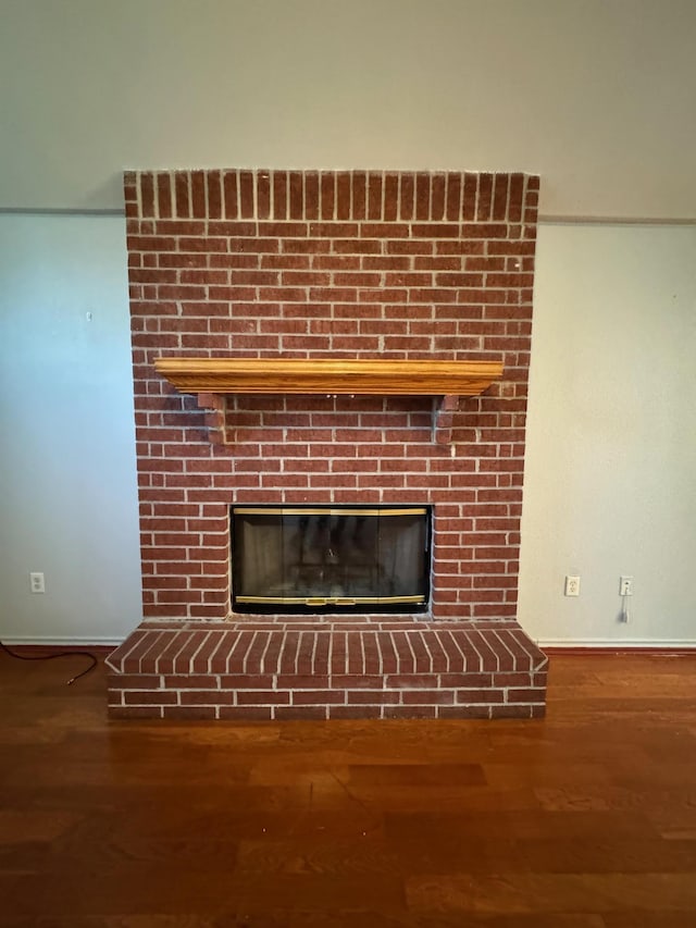 room details featuring wood-type flooring and a fireplace