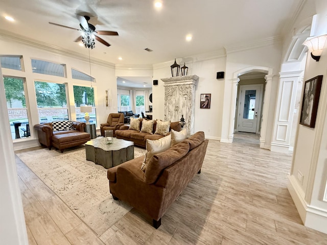 5065 Turner Rd, Orange, TX 77630 - living area with ornate columns, ceiling fan, crown molding, arched walkways, and light wood-type flooring