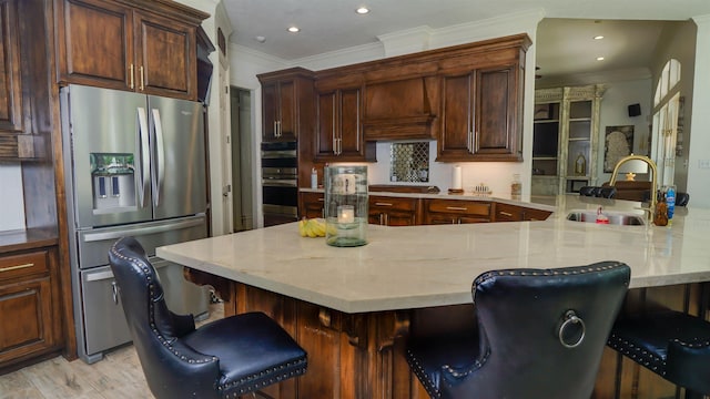5065 Turner Rd, Orange, TX 77630 - kitchen featuring appliances with stainless steel finishes, a breakfast bar area, crown molding, a peninsula, and recessed lighting
