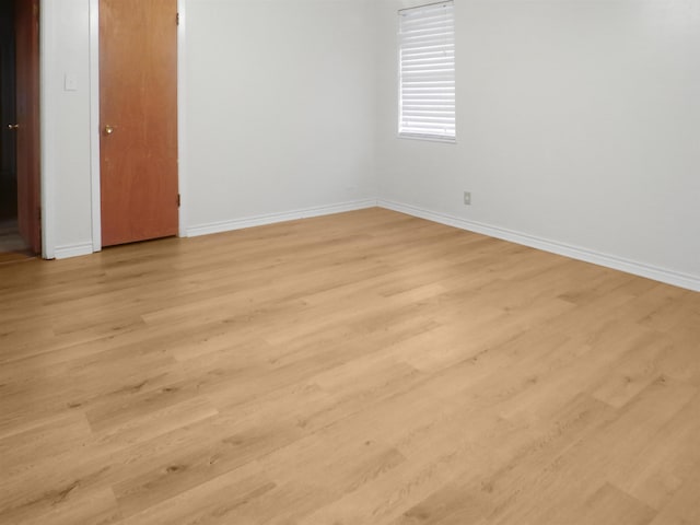 interior space with baseboards and light wood-style floors