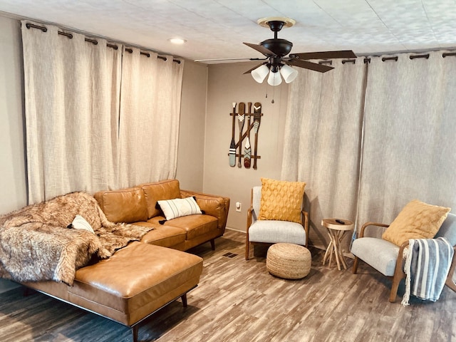 living area with ceiling fan and hardwood / wood-style floors