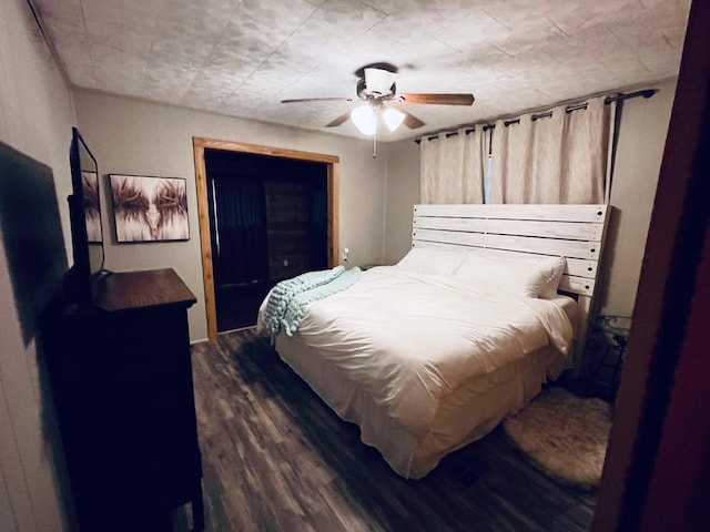 bedroom featuring dark hardwood / wood-style flooring and ceiling fan