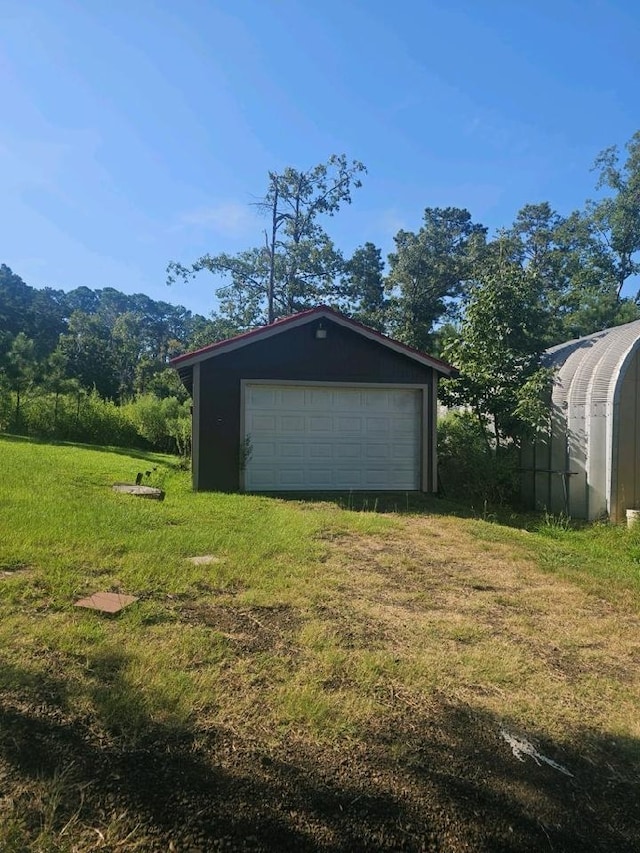 garage featuring a yard