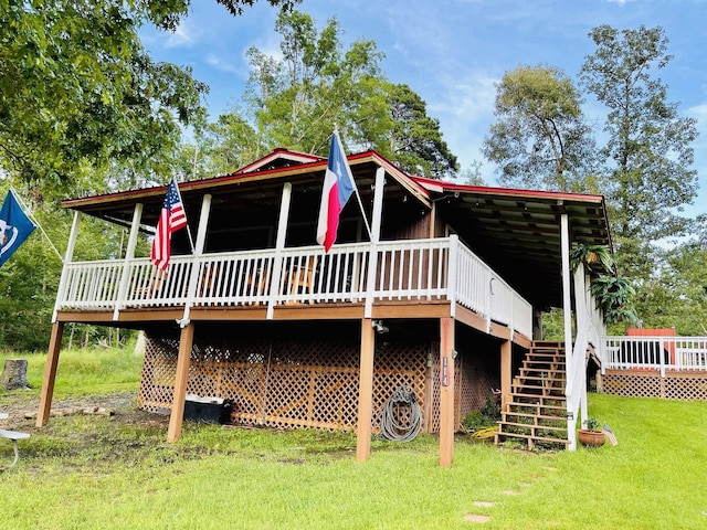 rear view of property featuring a lawn and a wooden deck