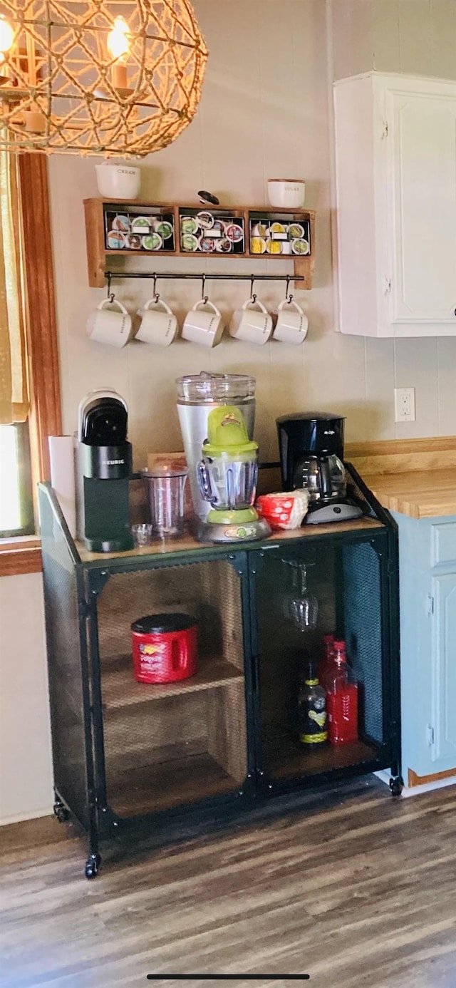 bar featuring white cabinets and hardwood / wood-style floors