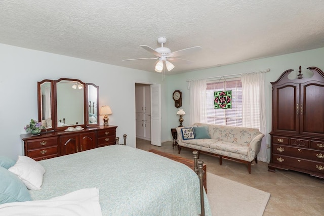 bedroom with ceiling fan, a closet, and a textured ceiling