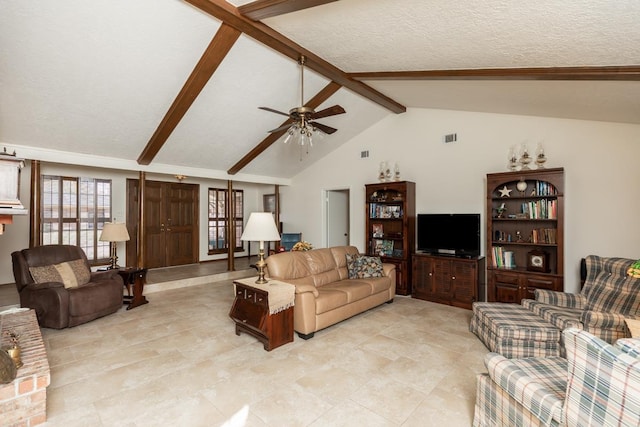 living room featuring ceiling fan, lofted ceiling with beams, and a textured ceiling