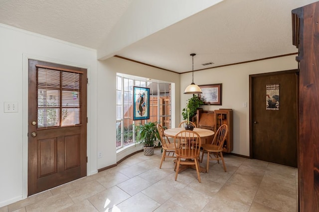 dining room with a textured ceiling and lofted ceiling