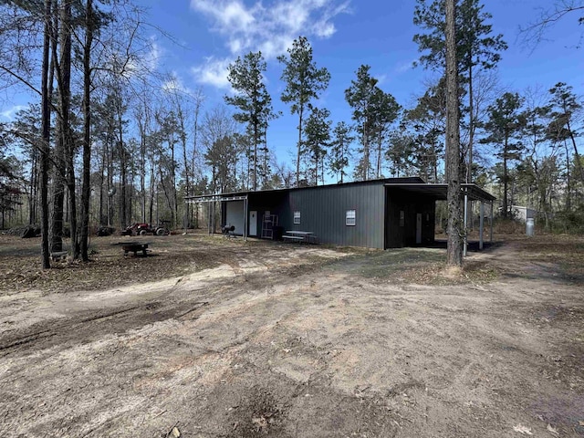 exterior space featuring dirt driveway