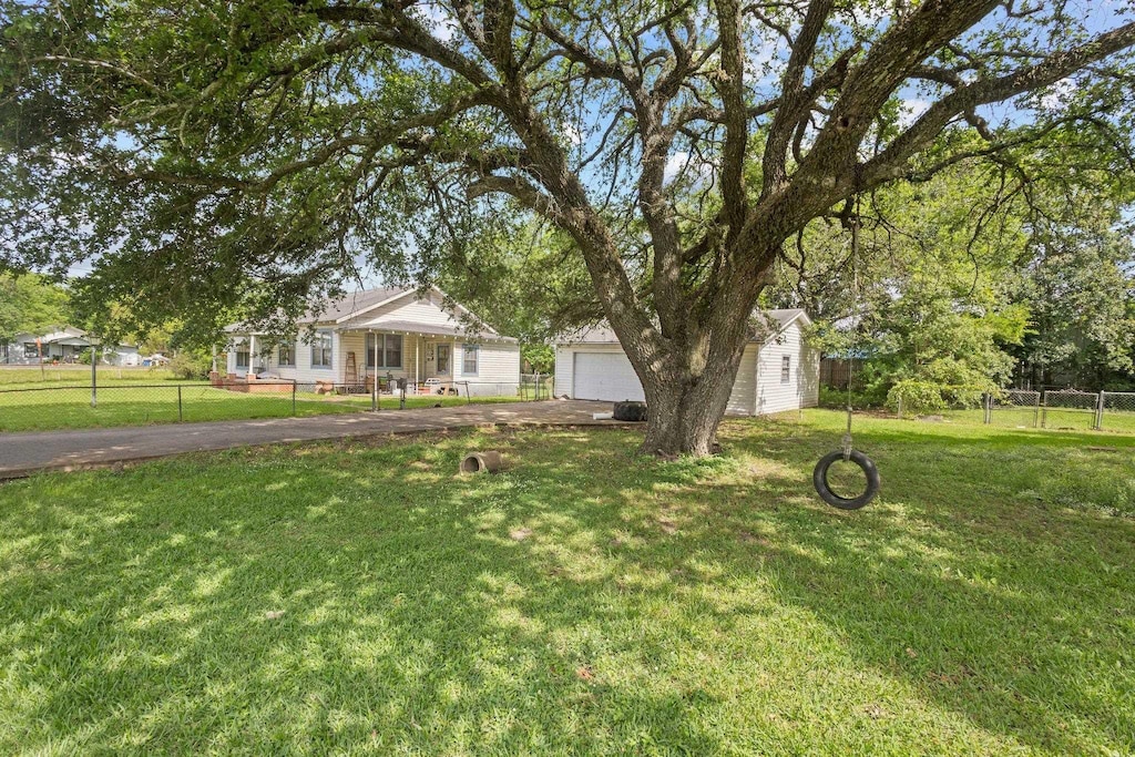 125 E Crosby St, Sour Lake, TX 77659 - view of front of home with an outbuilding and a garage