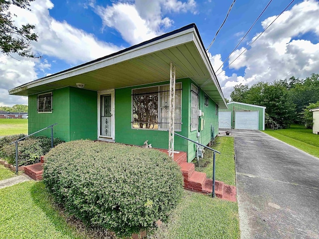 2349 Amino St, Port Arthur, TX 77640 - view of front of house with concrete block siding, an outbuilding, a garage, a porch, and driveway