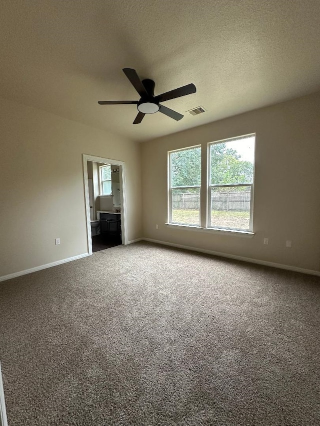 carpeted empty room with a textured ceiling and ceiling fan