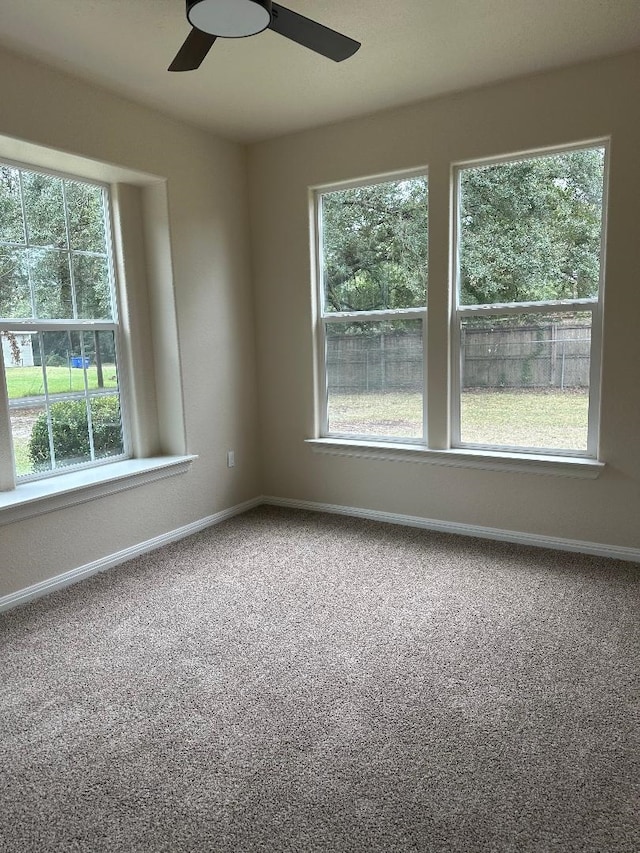 carpeted empty room featuring ceiling fan