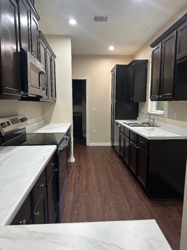 kitchen featuring stainless steel appliances, dark hardwood / wood-style floors, and sink