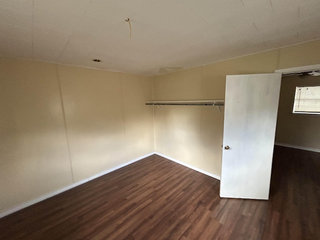 empty room with dark wood-style flooring