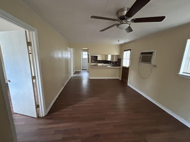 hall with a wall unit AC, baseboards, and dark wood-style flooring