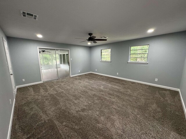 carpeted spare room with ceiling fan