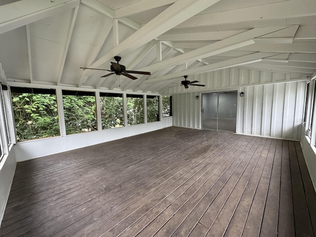 unfurnished sunroom featuring vaulted ceiling with beams and ceiling fan