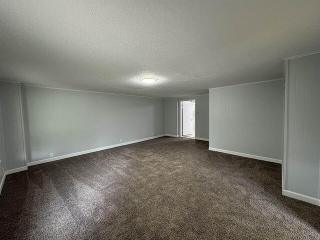 carpeted empty room with a textured ceiling