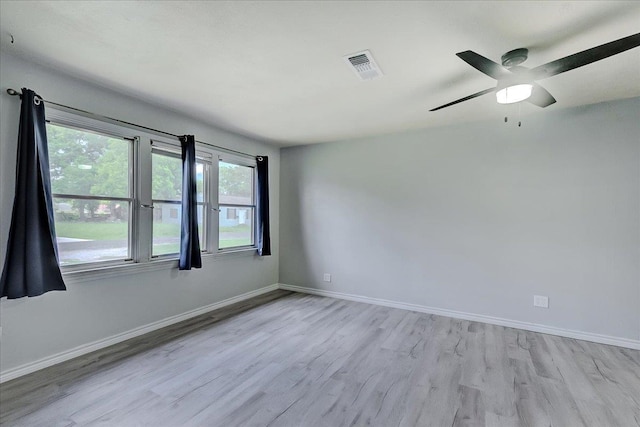 2125 10th St, Port Neches, TX 77651 - unfurnished room featuring light wood-type flooring, baseboards, and ceiling fan